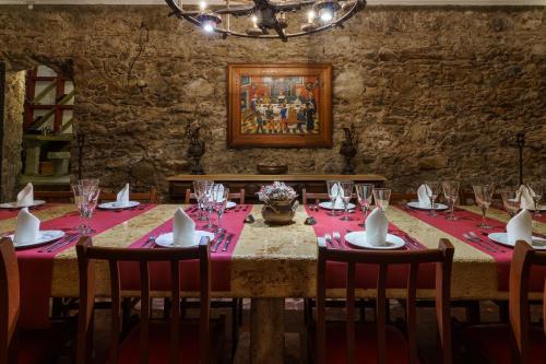 a dining room with a table with a red table cloth at Quinta de Santa Barbara by Heavens Sleepy in Constância
