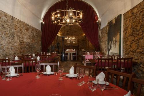 a dining room with a table and chairs and a chandelier at Quinta de Santa Barbara by Heavens Sleepy in Constância