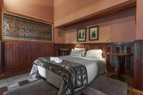 a bedroom with a large bed and a table at Quinta de Santa Barbara by Heavens Sleepy in Constância