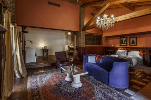 a living room with a blue couch and a bed at Quinta de Santa Barbara by Heavens Sleepy in Constância