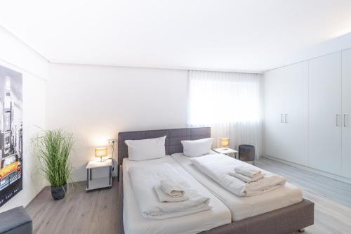 a bedroom with a large bed with two towels on it at Haus Alpsee in Immenstadt im Allgäu
