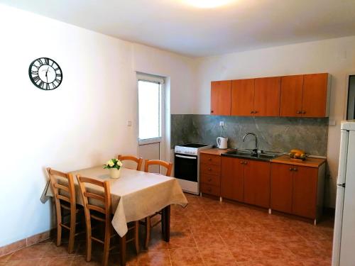 a kitchen with a table and a sink and a stove at Apartment Karlo - city center in Pag