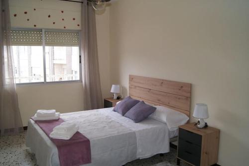a bedroom with a large bed and a window at Dona Branca in Quiroga
