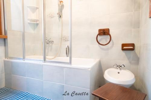 a bathroom with a shower and a toilet and a sink at La Corte di Franco - 4 appartamenti sul lago in Brusimpiano