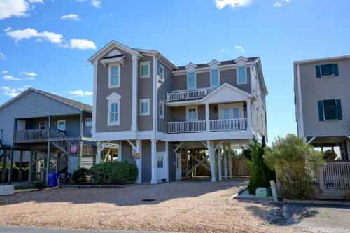 a large house on the beach with two condos at The Seventh Day in Holden Beach
