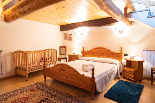 a bedroom with a large bed and a crib at La Corte di Franco - 4 appartamenti sul lago in Brusimpiano