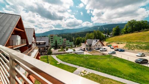 a view from a balcony of a town with a mountain at Triventi Mountain Residence, Sun & Snow in Karpacz