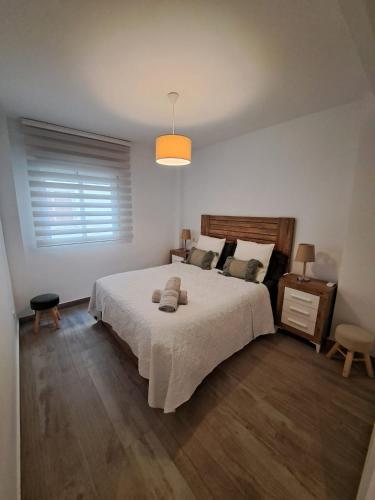 a bedroom with a large bed and a window at CASA ARBOL DE VIDA in Altea