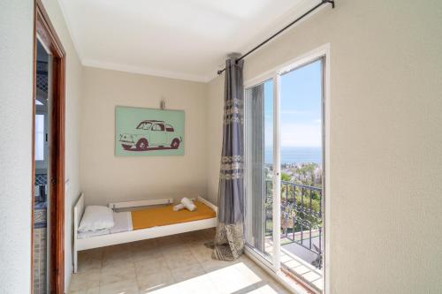 a bedroom with a bed and a large window at Villa Kenny Private Pool Casasol in Nerja