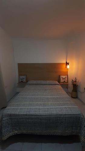 a bedroom with a bed with a comforter on it at DEPARTAMENTO LAPRIDA in La Banda