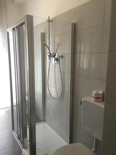 a bathroom with a shower with a glass door at Sunday Apartments in Mestre
