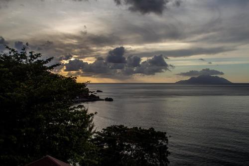 a view of the ocean with a cloudy sky at Treasure Cove Hotel & Restaurant in Bel Ombre