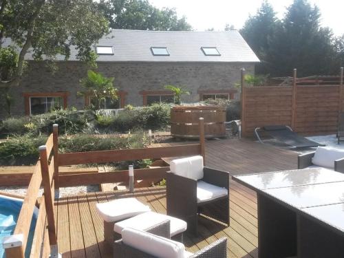 a backyard with a wooden deck and a swimming pool at Domaine naturiste libertin et épicurien B&B Spa in Condé-sur-Noireau