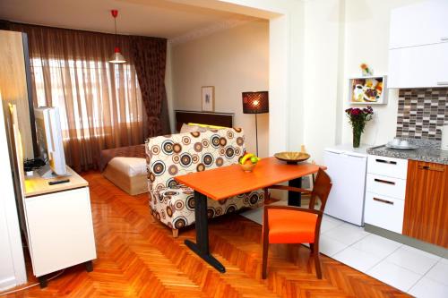 a kitchen and living room with a table and a couch at ABC Residence in Istanbul