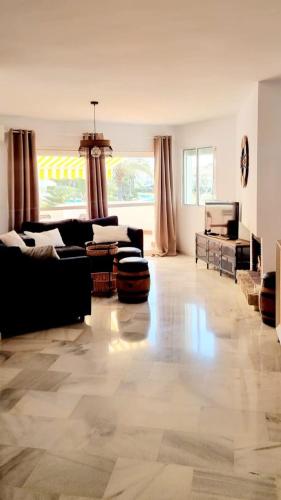 sala de estar amplia con sofá y mesa en Mijas Holiday en Fuengirola