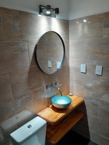 a bathroom with a sink and a mirror and a toilet at Dpto LUDIM 1 in Federación
