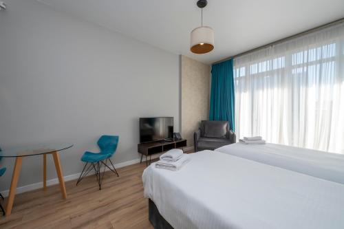 Postel nebo postele na pokoji v ubytování White Sails Residential Hotel