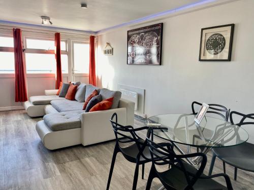 a living room with a couch and a glass table at Kennedy House in Blackpool