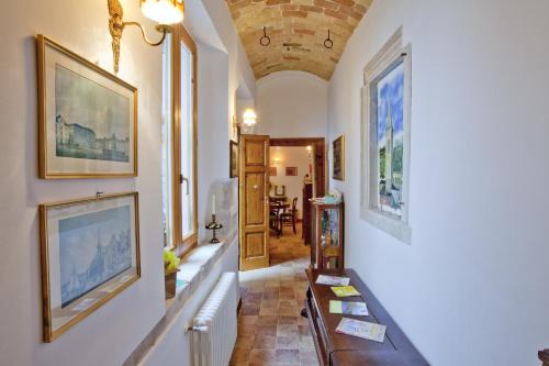 a hallway of a home with paintings on the walls at B&B Il Marchese Del Grillo in Sulmona