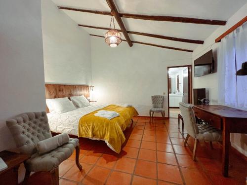 En eller flere senge i et værelse på Quinta da Utopia