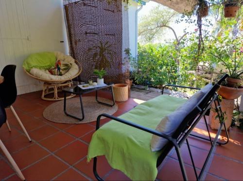 a living room with a chair and a table at Le Biabiany in Bouillante