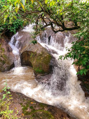 a stream of water rushing down a rocky slope at Espaço Monjolo in Barra do Garças