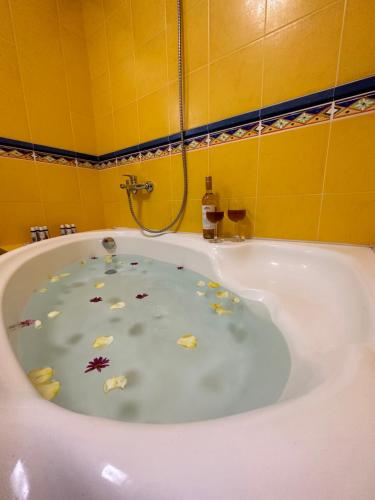 a bath tub with some leaves in the water at Aegean Blue House - Spectacular Seaview in Kalámion