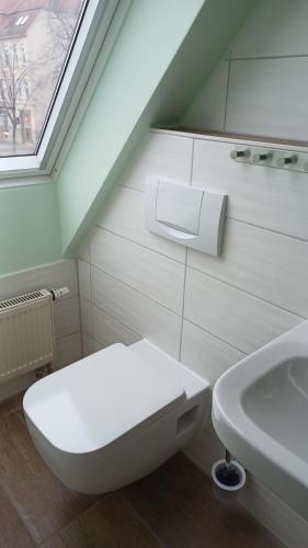 a bathroom with a toilet and a sink at Pension am Stern in Leipzig
