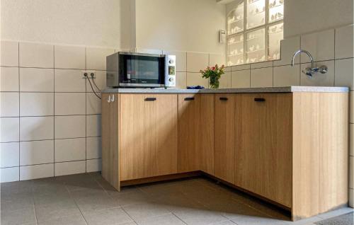 a kitchen with a tv on top of a counter at 2 Bedroom Awesome Home In Loon Op Zand in Loon op Zand