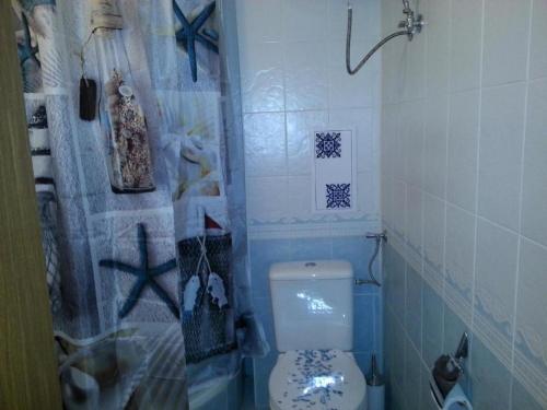 a bathroom with a toilet and a shower curtain at Monastery Apartment 14, St. Vlas in Sveti Vlas