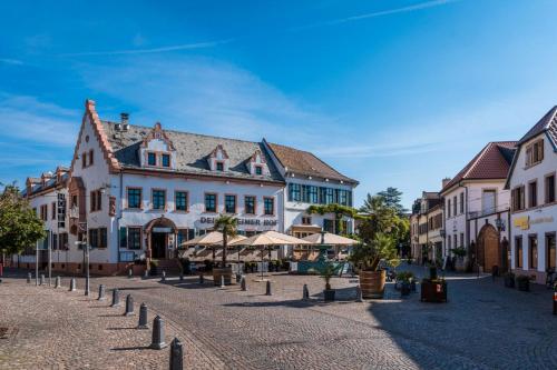 a cobblestone street in a town with buildings at Deidesheimer Hof in Deidesheim