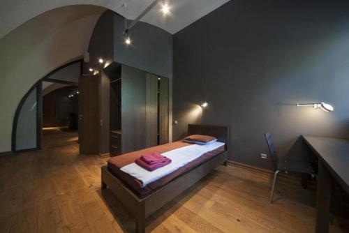 a bedroom with a bed and a desk in a room at Rothko Museum residences in Daugavpils
