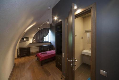 a hallway with a room with a bed and a bathroom at Rothko Museum residences in Daugavpils