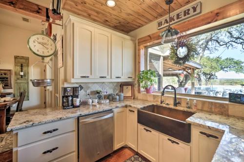 a kitchen with a sink and a large window at Secluded Country Hideaway with Fire Pit and Pool! in Blanco