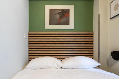a bed with two white pillows in a bedroom at Weber Hotel in Amsterdam