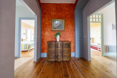 a room with a dresser in the middle of a room at Château des Grèzes in Agnat
