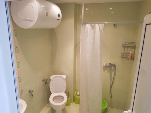 a bathroom with a toilet and a shower at Midia Grand Rezort in Aheloy
