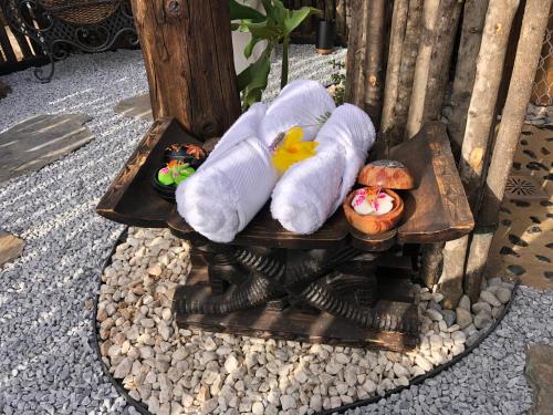 a wooden table with two stuffed animals and some pastries at Afrikan Krisant Tenerife, Casa Rural Ecologica in Arafo
