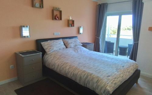 a bedroom with a large bed and a window at Mountain View in Alvor