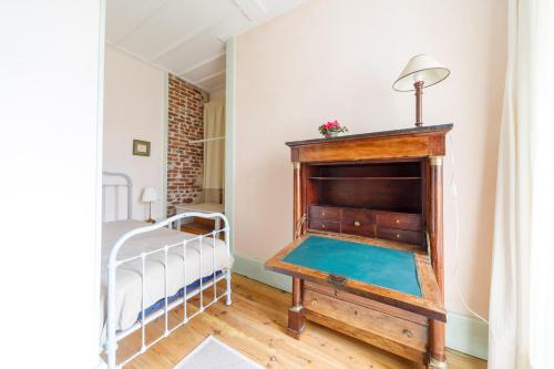 a room with a bed and a fireplace at Château des Grèzes in Agnat