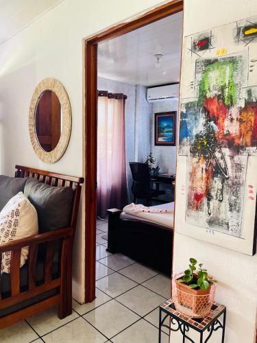 a living room with a couch and a mirror at Sweet Home Carrión in Fortuna