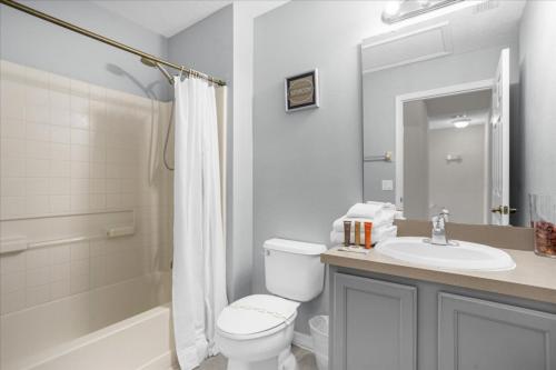 a bathroom with a toilet and a sink and a shower at 3 Bedrooms 25 Bathrooms Encantada 3091 Yl in Orlando