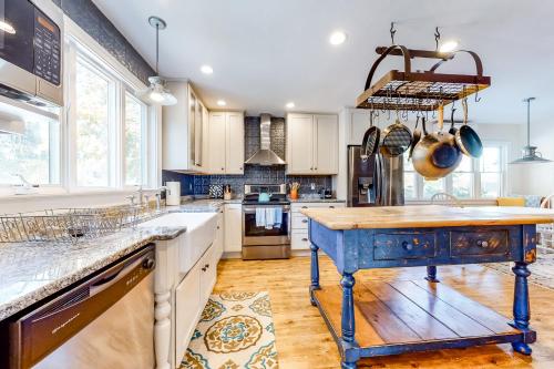 a kitchen with a blue island in the middle at Pleasant Bay Retreat in Orleans