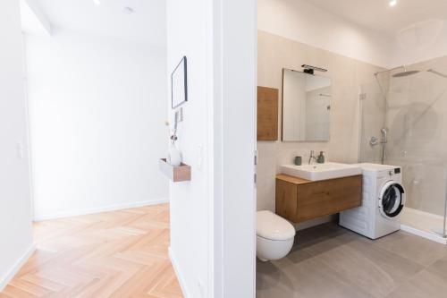 a bathroom with a sink and a washing machine at Nadland Apartments B61 in Vienna
