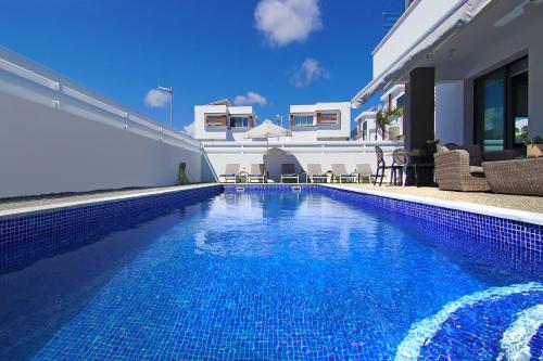 a swimming pool in front of a house at Villa Martha in Protaras