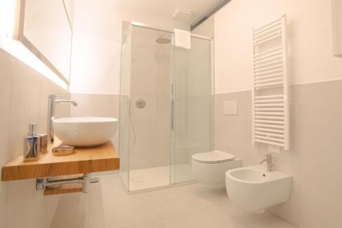 a bathroom with a shower and a toilet and a sink at Regina di Verona - Royal Welcome in Verona