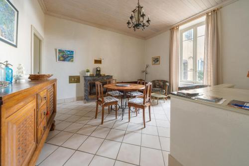 a kitchen and dining room with a table and chairs at Château des Grèzes in Agnat
