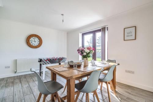 a dining room with a wooden table and chairs at Venn Down Lakes in Boscastle