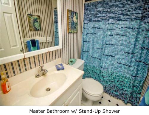 a bathroom with a sink toilet and a shower at Condo By The Sea! in Cocoa Beach