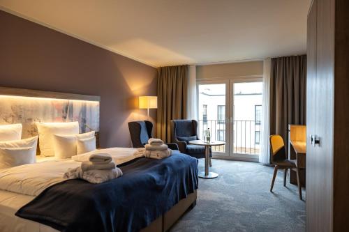 Un pat sau paturi într-o cameră la Santé Royale Rügen Resort